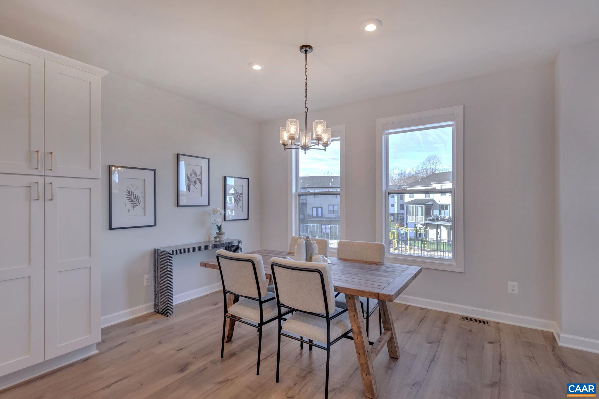 1842 Fowler Street Charlottesville, VA 22901 - Photo 17 of 44 a dining room with furniture a chandelier and wooden floor