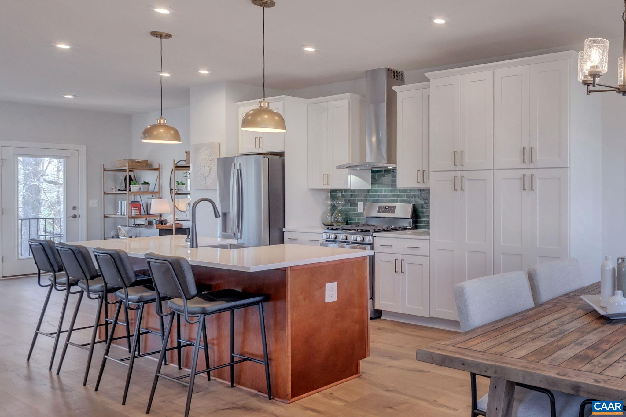 1842 Fowler Street Charlottesville, VA 22901 - Photo 19 of 44 a kitchen with kitchen island granite countertop a table chairs a sink dishwasher a refrigerator and microwave