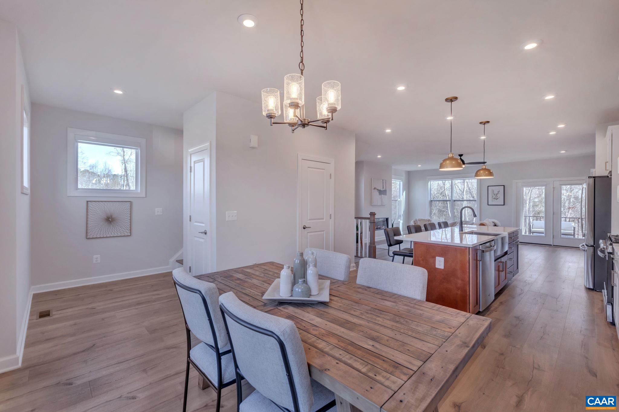 1842 Fowler Street Charlottesville, VA 22901 - Photo 20 of 44 a view of a dining room and livingroom with furniture wooden floor a chandelier