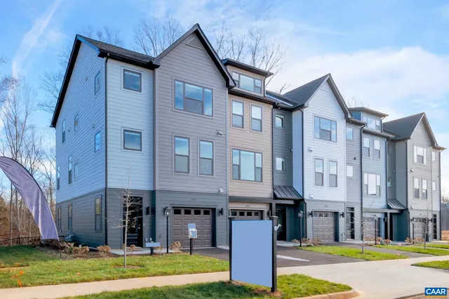 a front view of a residential apartment building with a yard