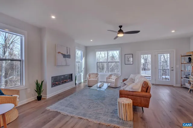 a living room with furniture a wooden floor and a window