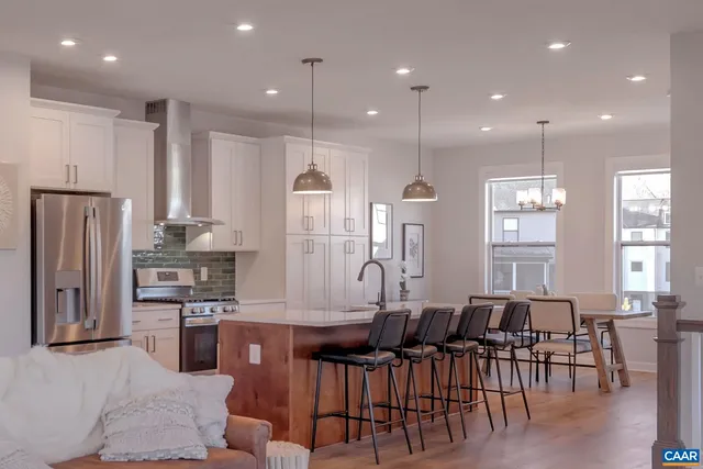 a large kitchen with a table and chairs