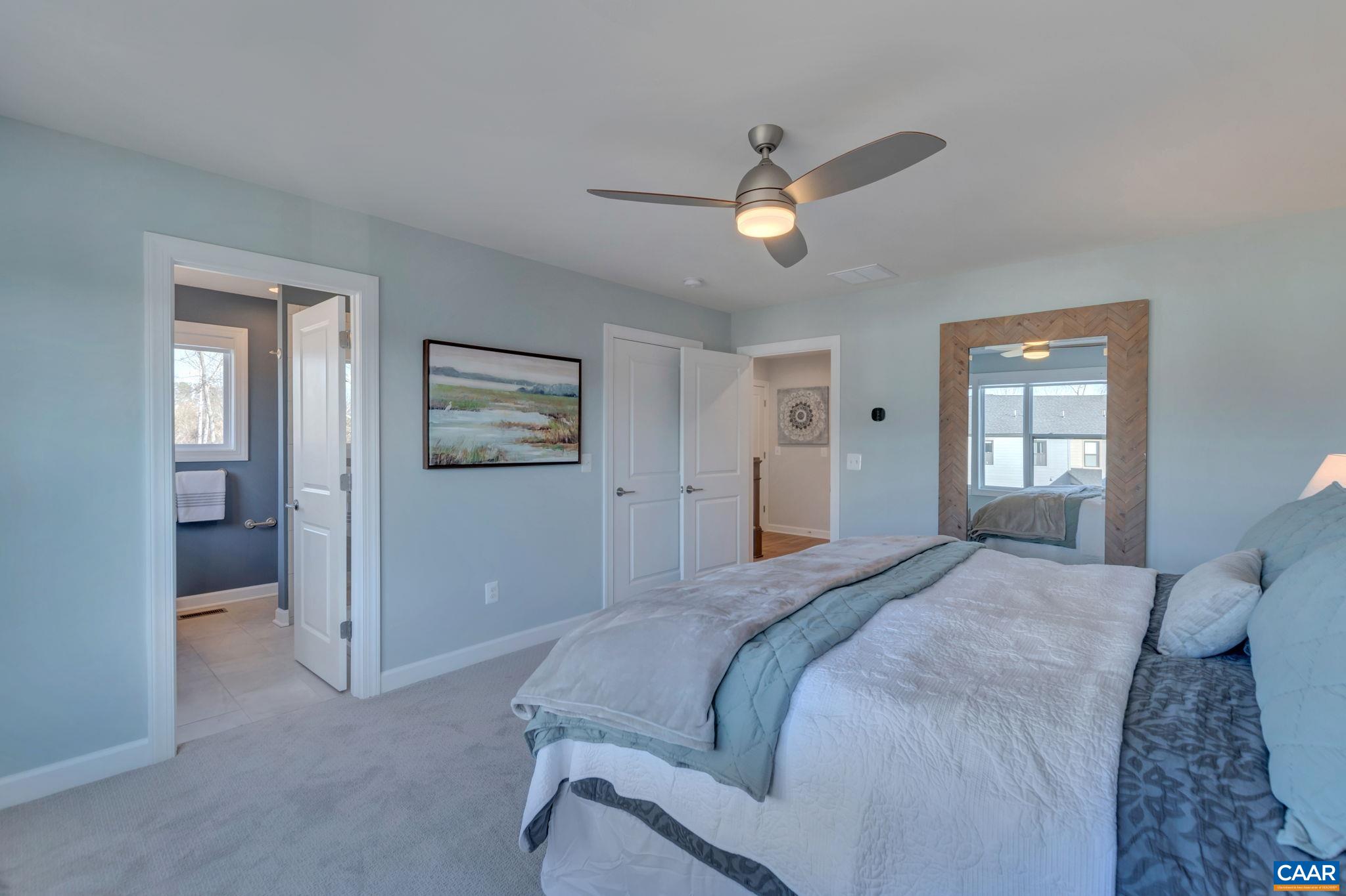 1842 Fowler Street Charlottesville, VA 22901 - Photo 32 of 44 a bedroom with a large bed and a chandelier