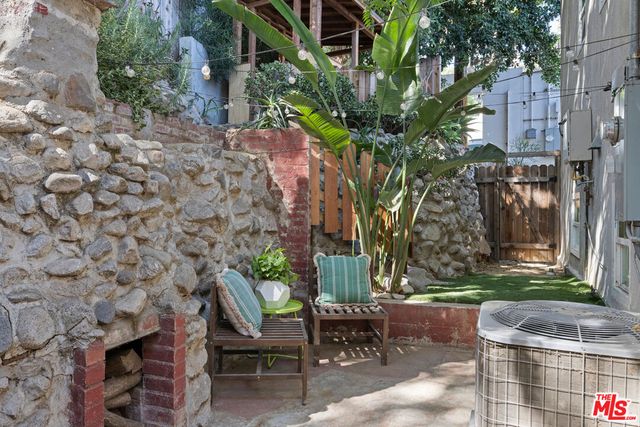 a view of patio with table and chairs and potted plants