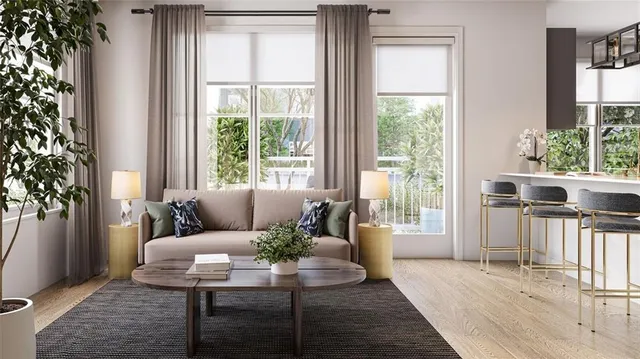 a living room with furniture and a potted plant