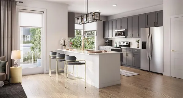 a kitchen with stainless steel appliances kitchen island granite countertop a refrigerator a stove top oven a sink dishwasher and white cabinets with wooden floor