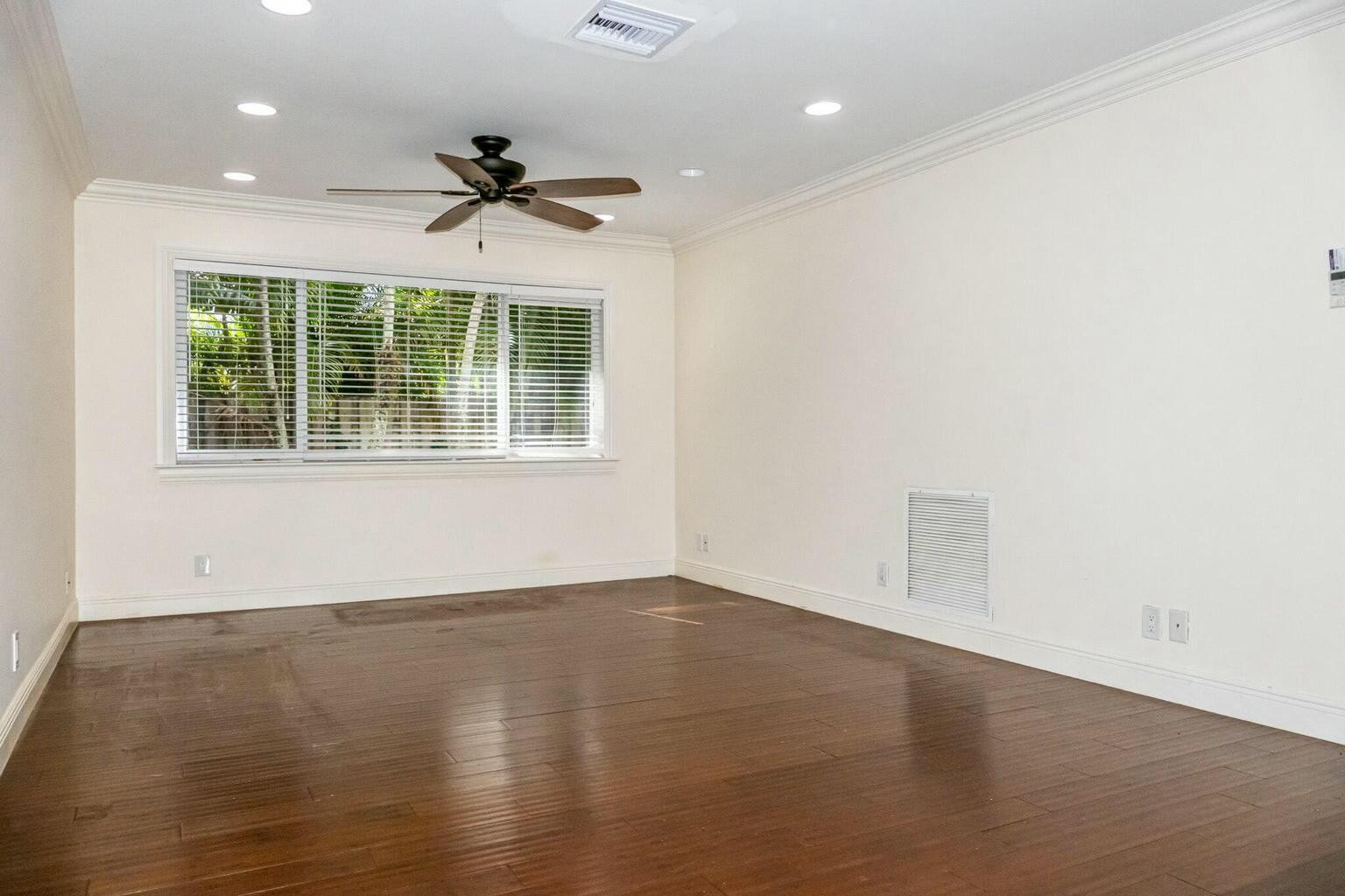 18014 Perigon Way Jupiter, FL 33458 - Photo 13 of 35 an empty room with wooden floor and windows