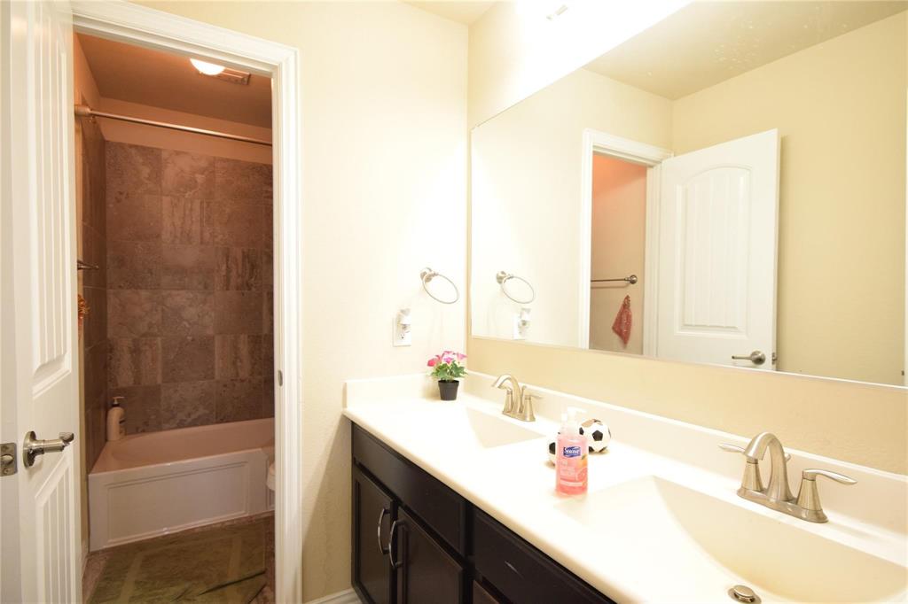 12421 Hitch Rack Way McKinney, TX 75071 - Photo 10 of 21 a bathroom with a sink a shower and a mirror