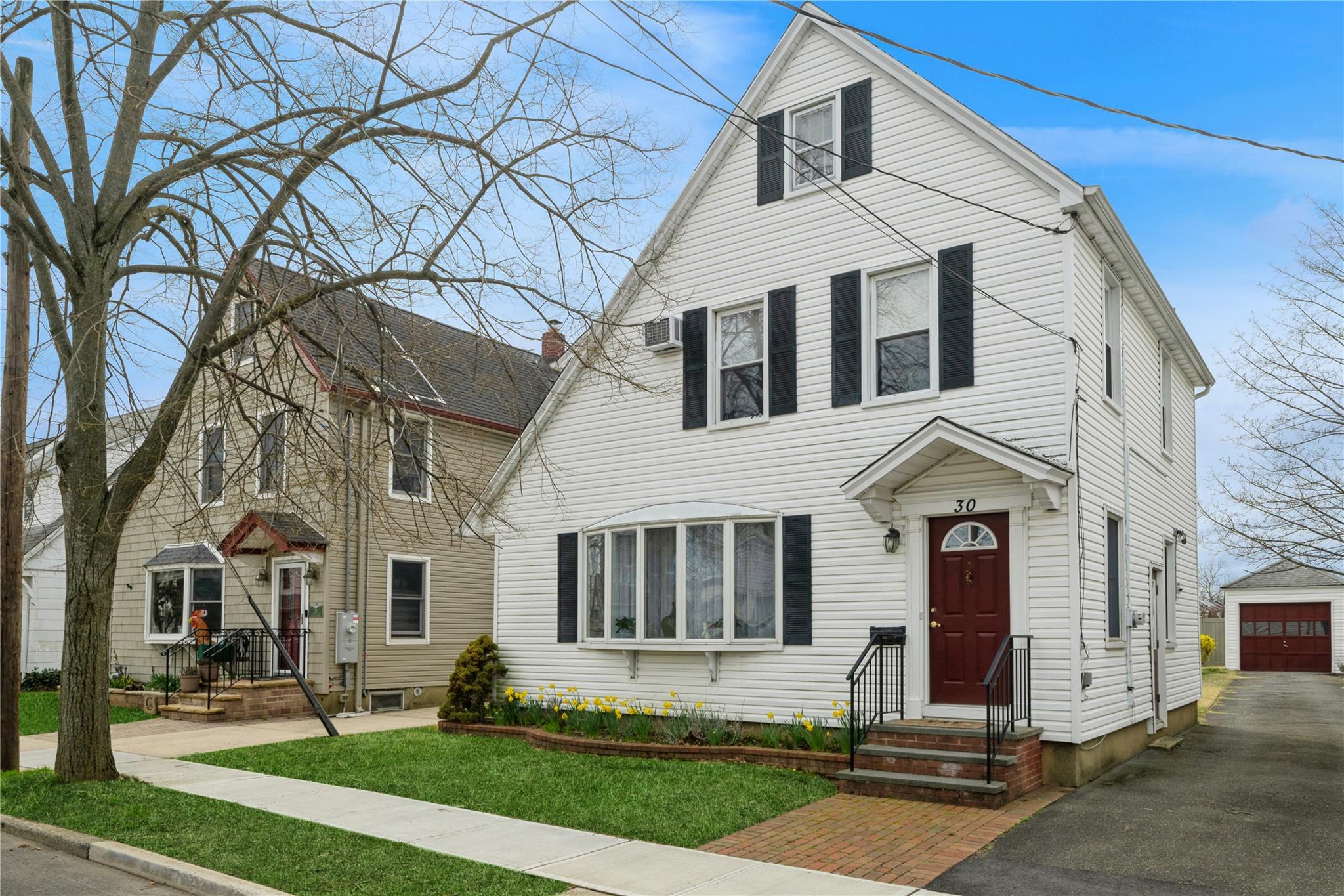 View of front of house featuring an outdoor structure and a detached garage