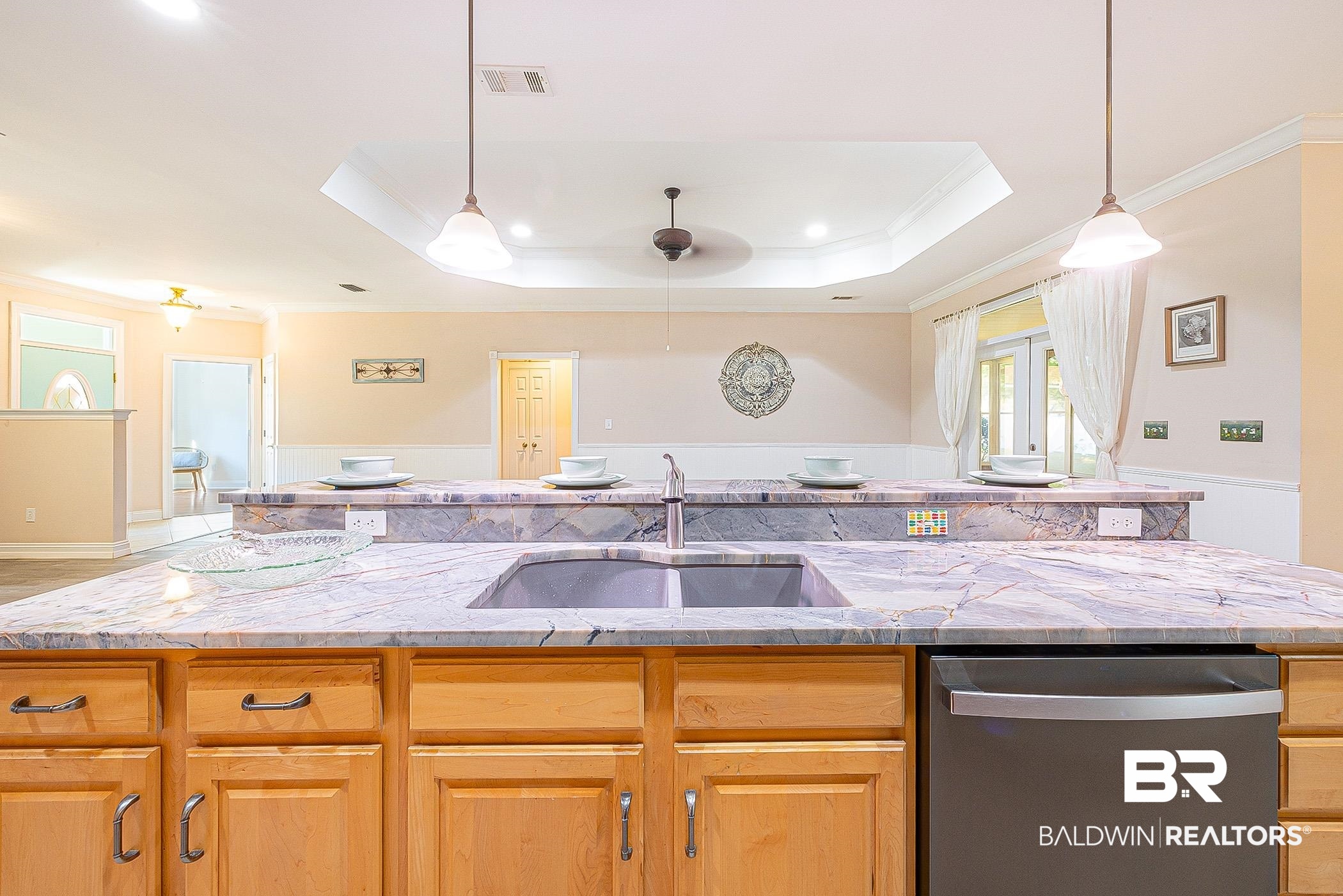 133 Mark Twain Loop Foley, AL 36535 - Photo 19 of 61 Kitchen featuring sink, a kitchen island with sink, light stone countertops, stainless steel dishwasher, and a raised ceiling