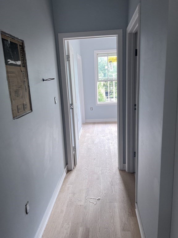 183 West Fifth Street, Unit 1 Boston, MA 02127 - Photo 7 of 16 a view of hallway with wooden floor and window