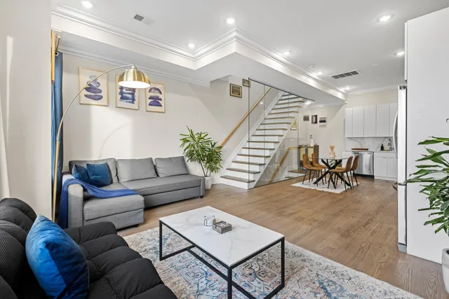 a living room with furniture and wooden floor