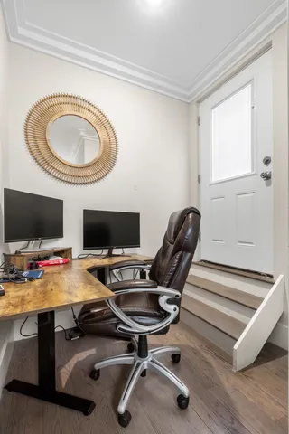 a view of a workspace with furniture and a window