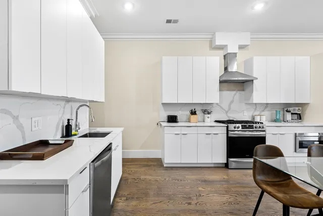 a kitchen with a stove cabinets and a sink
