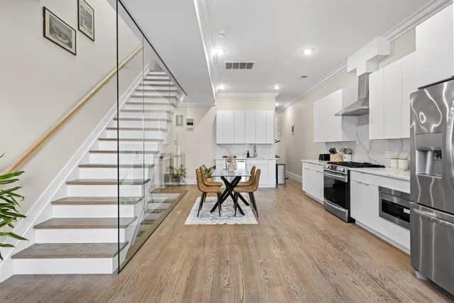 a view of kitchen with sink and wooden floor