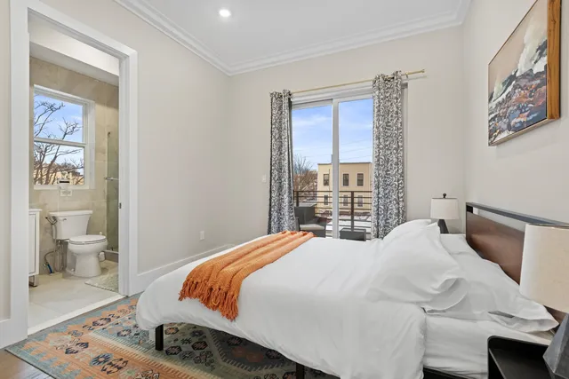 a bedroom with a bed and a painting on the wall