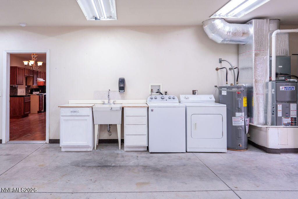 2931 Airport Road Carson City, NV 89706 - Photo 12 of 35 a utility room with cabinets dryer and washer