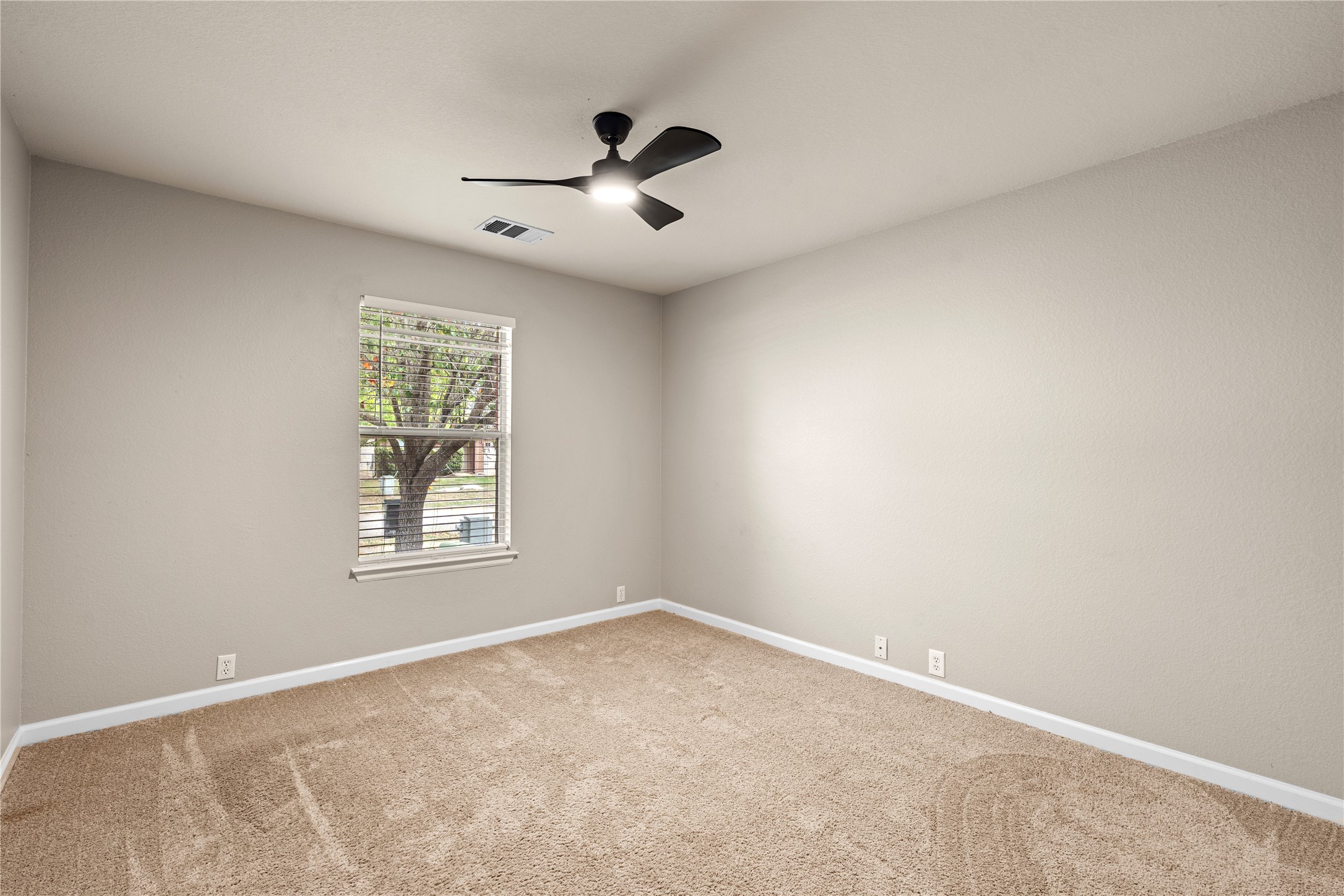 292 Spruce Drive Kyle, TX 78640 - Photo 11 of 25 an empty room with windows and cabinet