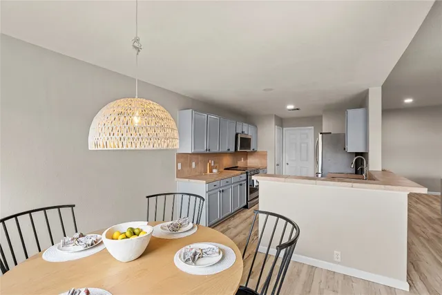 a kitchen with cabinets and stainless steel appliances
