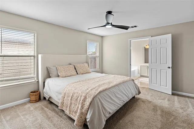 a bedroom with a large bed and a window