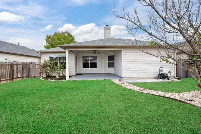 a front view of a house with a yard and green space