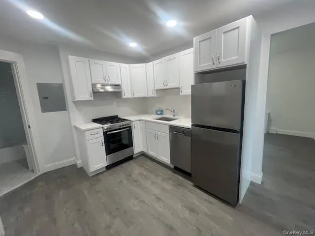 a kitchen with cabinets and white stainless steel appliances