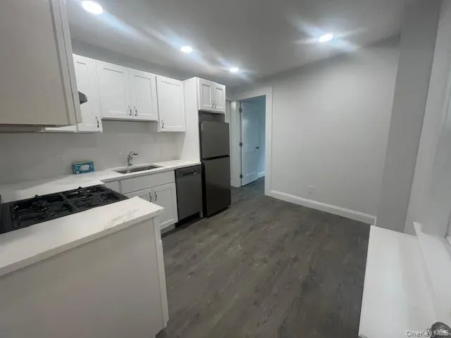 a kitchen with a sink a stove and refrigerator
