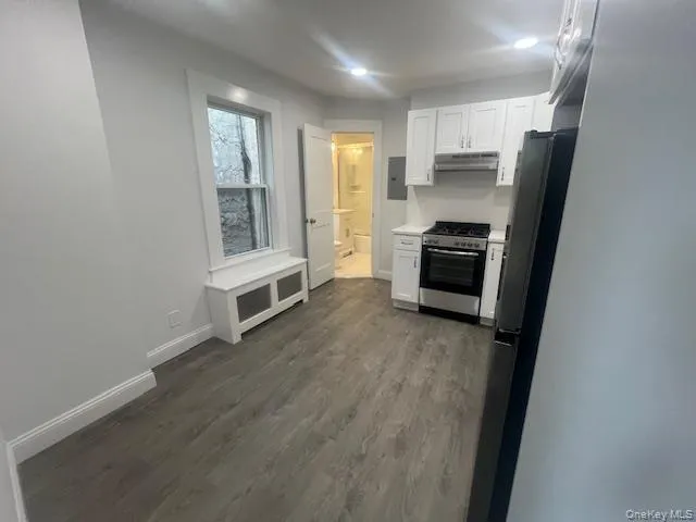 a kitchen with stainless steel appliances a refrigerator and a stove top oven