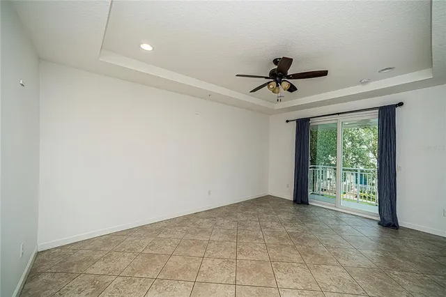 a view of a livingroom with a ceiling fan and window