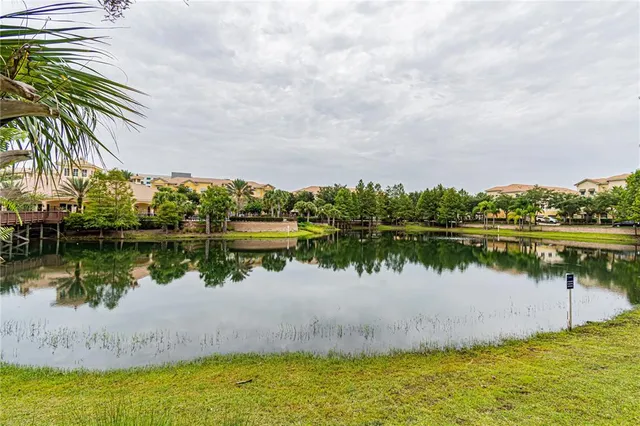 a living room with furniture a wooden floor and a large window