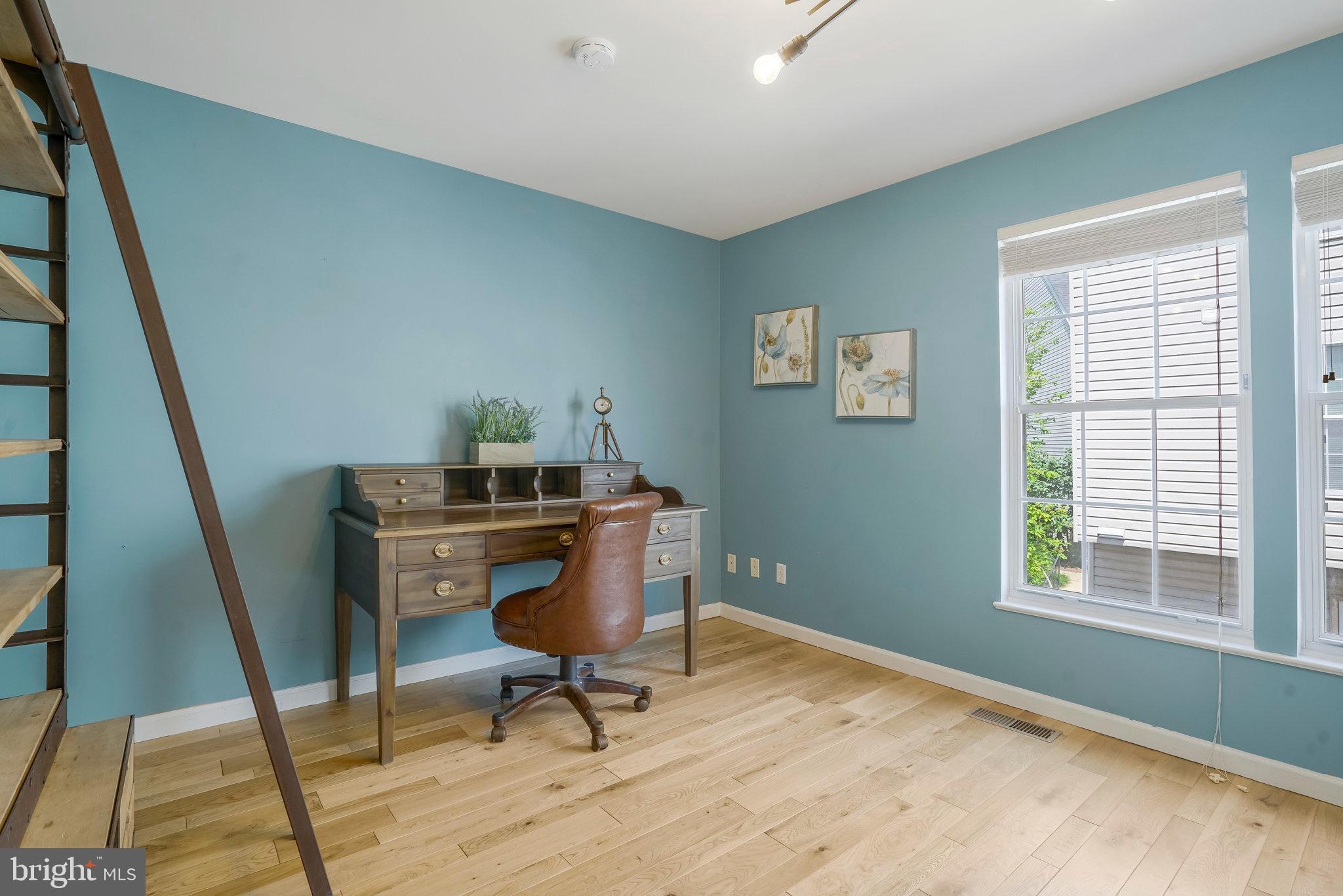 2181 Shirlington Road Arlington, VA 22206 - Photo 19 of 48 a view of a workspace with furniture and a window