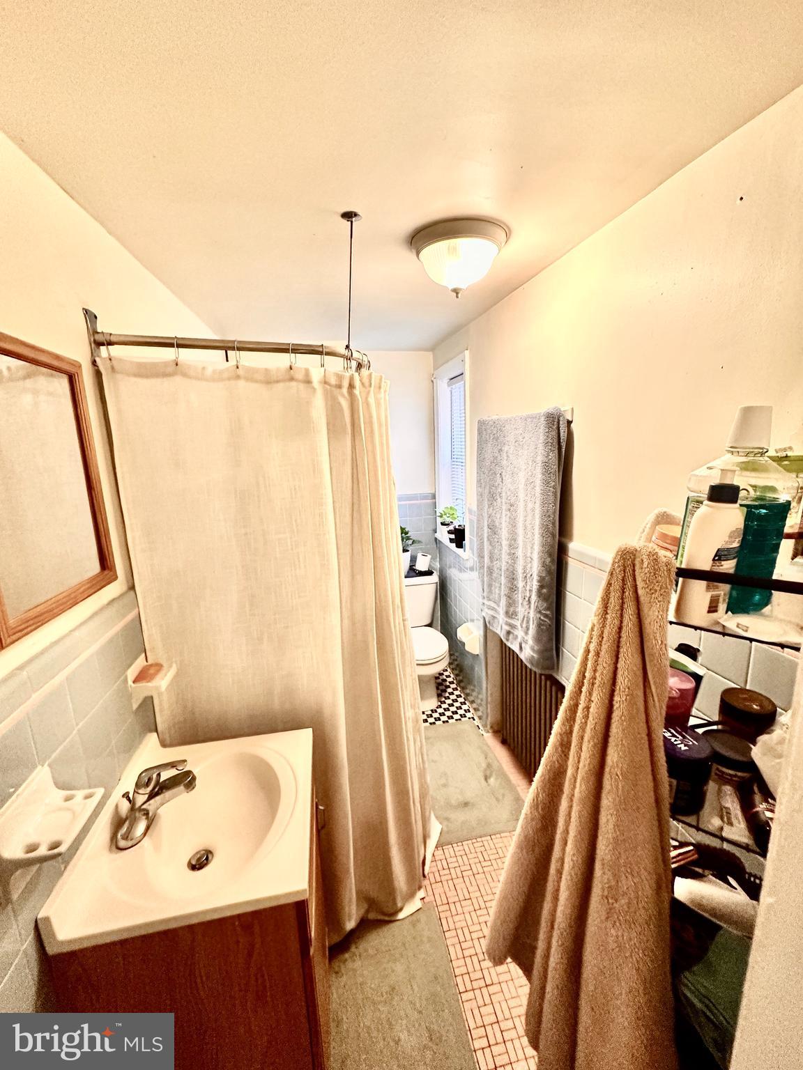 243 West Rittenhouse Street, Unit 2C Philadelphia, PA 19144 - Photo 7 of 9 a view of a living room with furniture and a floor to ceiling window