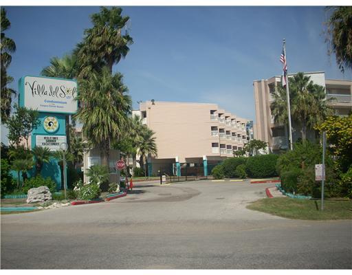 3938 Surfside, Unit 2117 Corpus Christi, TX 78402 - Photo 1 of 10 a sign board with buildings in the background
