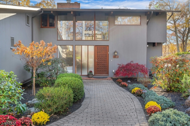 a front view of a house with outdoor seating
