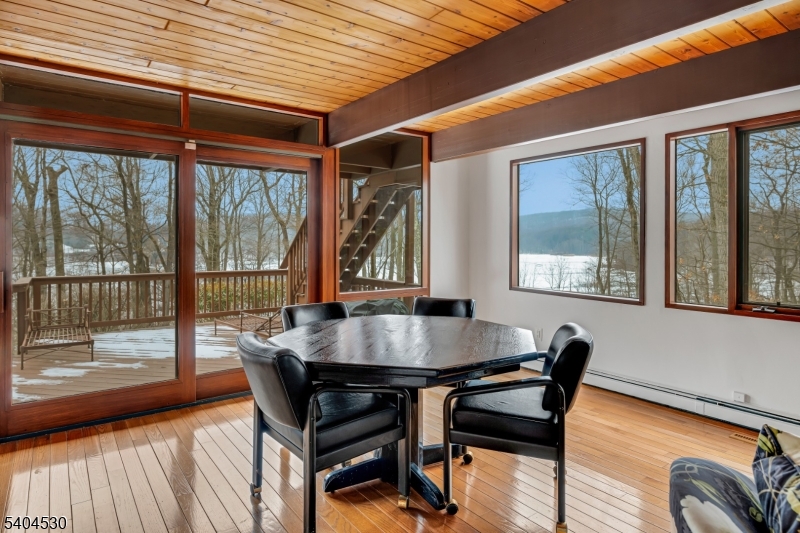 39 Woodland Road Morristown, NJ 07960 - Photo 15 of 34 a dining room with wooden floor a glass table and chairs