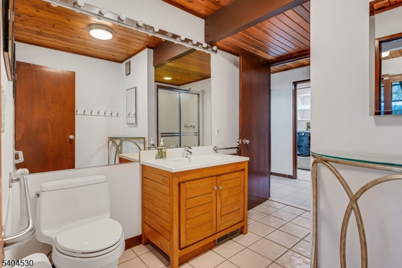 39 Woodland Road Morristown, NJ 07960 - Photo 17 of 34 a bathroom with a sink a toilet and mirror