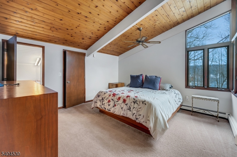 39 Woodland Road Morristown, NJ 07960 - Photo 22 of 34 a bedroom with a large bed and balcony view