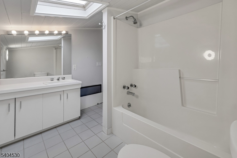 39 Woodland Road Morristown, NJ 07960 - Photo 23 of 34 a bathroom with a sink a toilet and shower