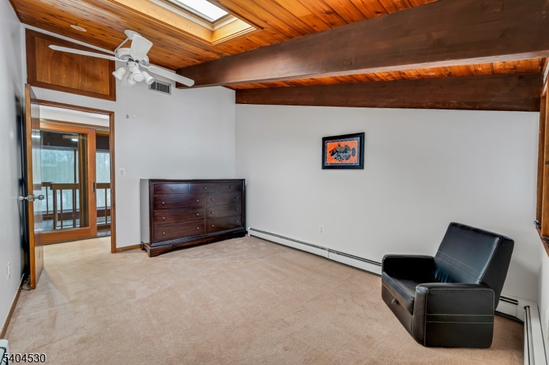 39 Woodland Road Morristown, NJ 07960 - Photo 27 of 34 a living room with furniture and a flat screen tv