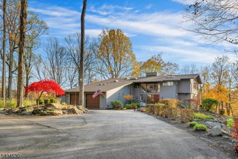 39 Woodland Road Morristown, NJ 07960 - Photo 3 of 34 a front view of a house with a yard and potted plants