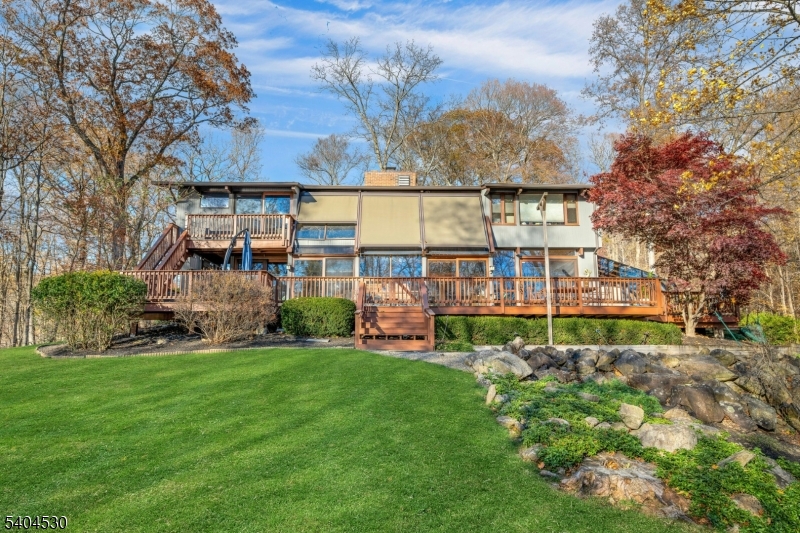 39 Woodland Road Morristown, NJ 07960 - Photo 32 of 34 a view of a house with a big yard and large trees