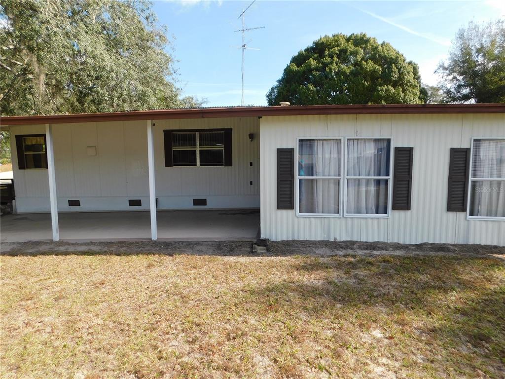 34912 Hawkiowa Road Dade City, FL 33523 - Photo 2 of 7 a view of a house with a yard