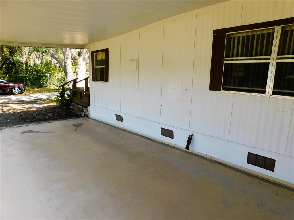 34912 Hawkiowa Road Dade City, FL 33523 - Photo 3 of 7 a view of an empty room with a window