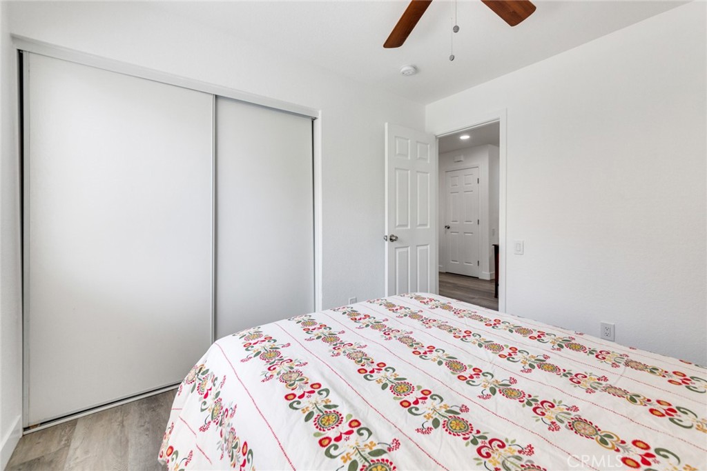 4179 Shellicia Circle Jurupa Valley, CA 92509 - Photo 12 of 25 a bedroom with a bed and a chandelier