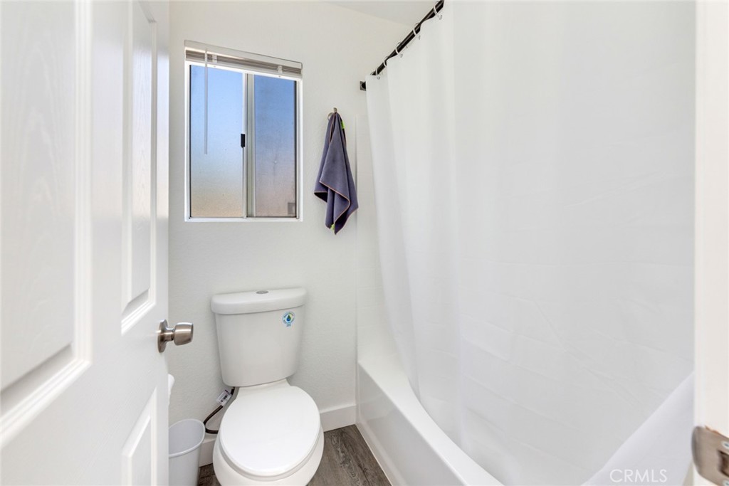 4179 Shellicia Circle Jurupa Valley, CA 92509 - Photo 13 of 25 a white toilet sitting next to a white sink and vanity