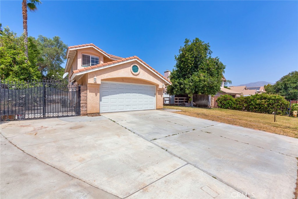 4179 Shellicia Circle Jurupa Valley, CA 92509 - Photo 2 of 25 a front view of a house with a yard and garage