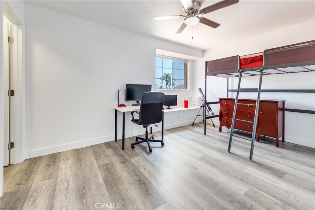 4179 Shellicia Circle Jurupa Valley, CA 92509 - Photo 21 of 25 a workspace with furniture wooden floor and windows
