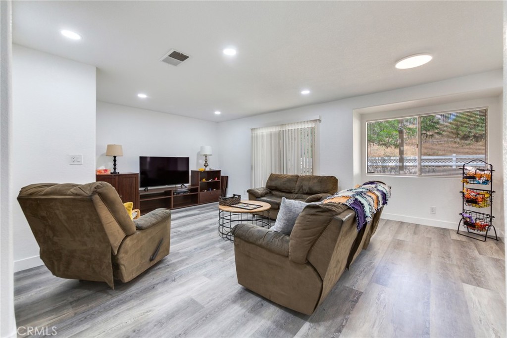 4179 Shellicia Circle Jurupa Valley, CA 92509 - Photo 5 of 25 a living room with furniture a flat screen tv and a large window
