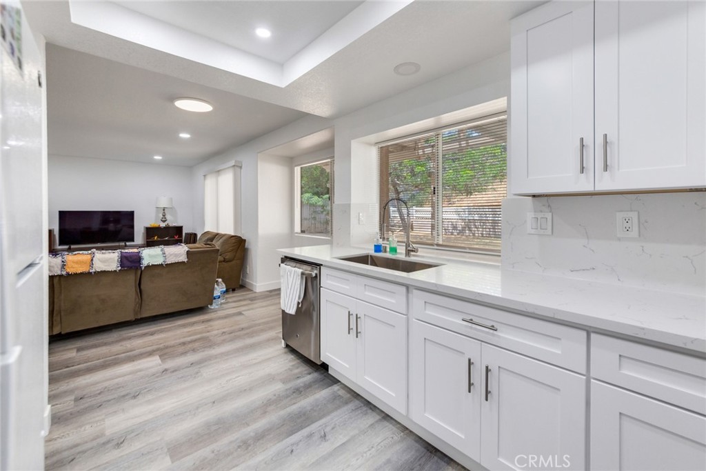 4179 Shellicia Circle Jurupa Valley, CA 92509 - Photo 7 of 25 a large white kitchen with cabinets a sink and a window
