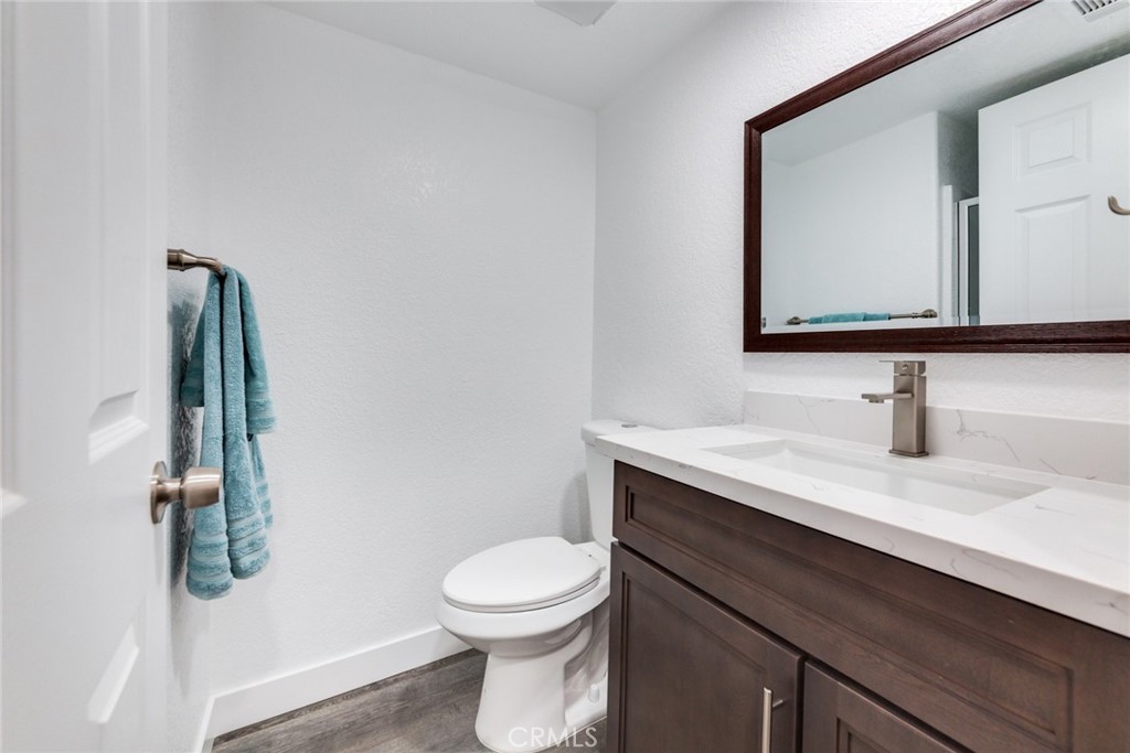 4179 Shellicia Circle Jurupa Valley, CA 92509 - Photo 10 of 25 a bathroom with a toilet sink and mirror